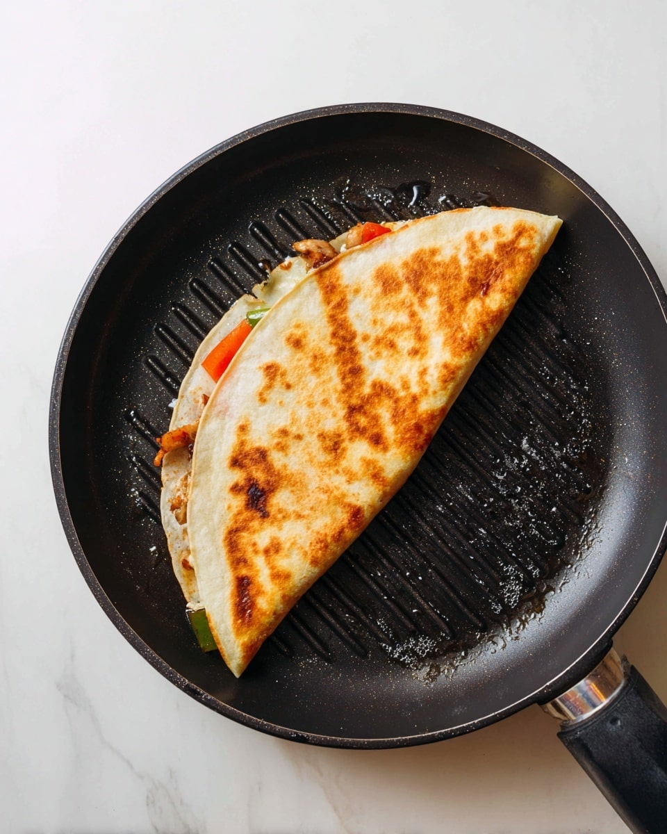 A folded tortilla with a golden brown, slightly crispy surface lies inside a black grill pan with a few grill lines visible underneath; the tortilla covers colorful fillings peeking out slightly on one side, including green, red, and orange pieces likely from vegetables and protein. The pan rests on a white marbled surface, with small bubbles of oil or butter sizzling around the edges of the tortilla. photo taken with an iphone --ar 4:5 --v 7