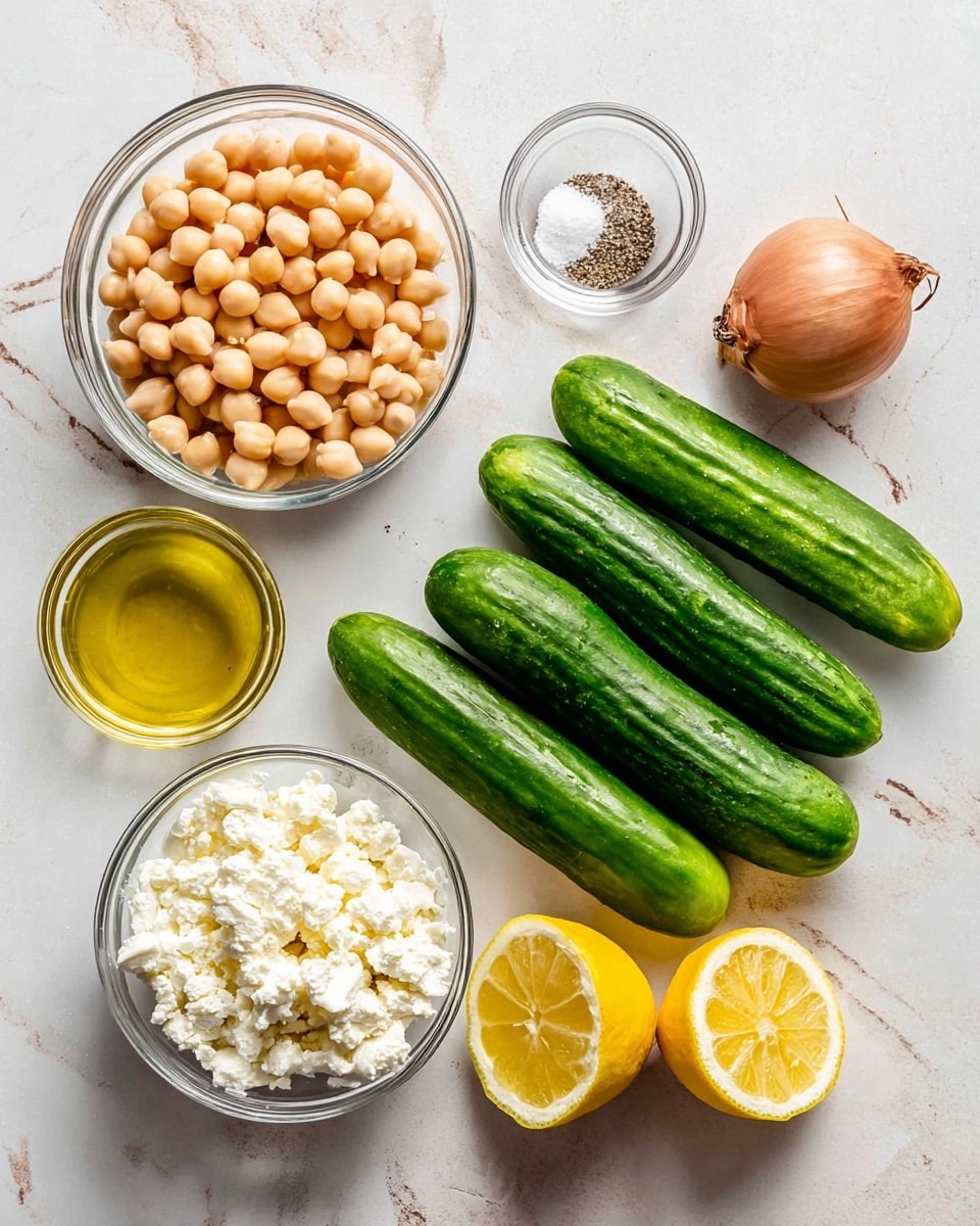 This image shows fresh ingredients on a white marbled surface: a clear glass bowl filled with round, light beige chickpeas in the top left, a small clear bowl with white salt and black pepper in the center, four whole bright green cucumbers stacked together on the right, a small clear bowl of golden olive oil just above the cucumbers, a shallow clear glass bowl filled with white crumbly cheese on the bottom left, one whole brown shallot at the top right, and two lemon halves showing their yellow juicy interior at the bottom center photo taken with an iphone --ar 4:5 --v 7