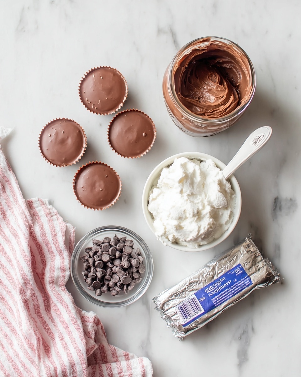 The image shows a white marbled surface with various dessert ingredients arranged neatly. On the left, there are five small chocolate cups with a smooth, shiny milk chocolate top. Near the top center, there is an open jar filled with thick, dark brown chocolate spread. Below it, a white bowl holds a fluffy, white creamy substance with a white spoon inside. To the bottom right, a wrapped silver package of cream cheese is visible with blue text on it. In the lower center, a small clear glass bowl contains a handful of dark chocolate chips. A pink and white striped cloth is draped on the lower left corner. photo taken with an iphone --ar 4:5 --v 7