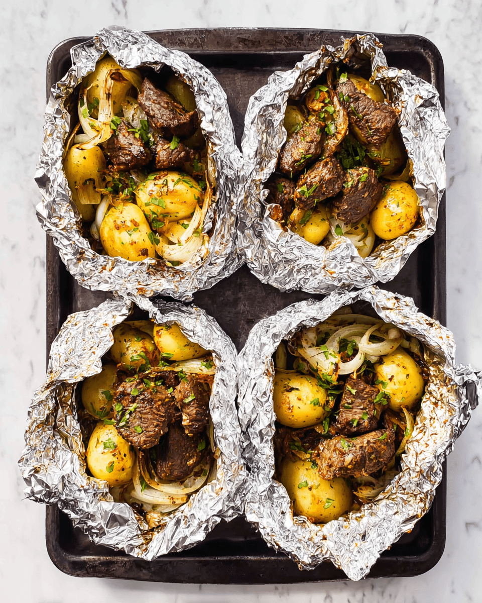 The image shows four open foil packets on a dark baking tray, each containing two main layers: the bottom layer has golden roasted baby potatoes mixed with thin, light beige onion slices and sprinkled with green herbs. The top layer consists of browned, cooked beef pieces with a slightly charred texture. The foil is crinkled around the edges, holding the food inside. The whole scene is set against a white marbled surface. photo taken with an iphone --ar 4:5 --v 7