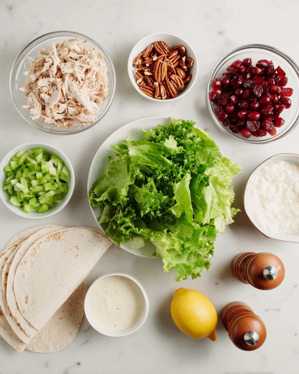 The image shows several bowls and a plate arranged on a white marbled surface. There is a white bowl with bright green leafy lettuce in the middle. Around it, from left to right, there is a clear glass bowl with light shredded chicken, a small white bowl with chopped pecans, a small white bowl with creamy white sauce, and a small white bowl with chopped green celery. To the right of the lettuce, there is a small white bowl filled with red cherries cut in halves, three folded white tortillas stacked on top of each other, a whole yellow lemon, and two wooden salt and pepper shakers. The photo was taken with an iphone --ar 4:5 --v 7