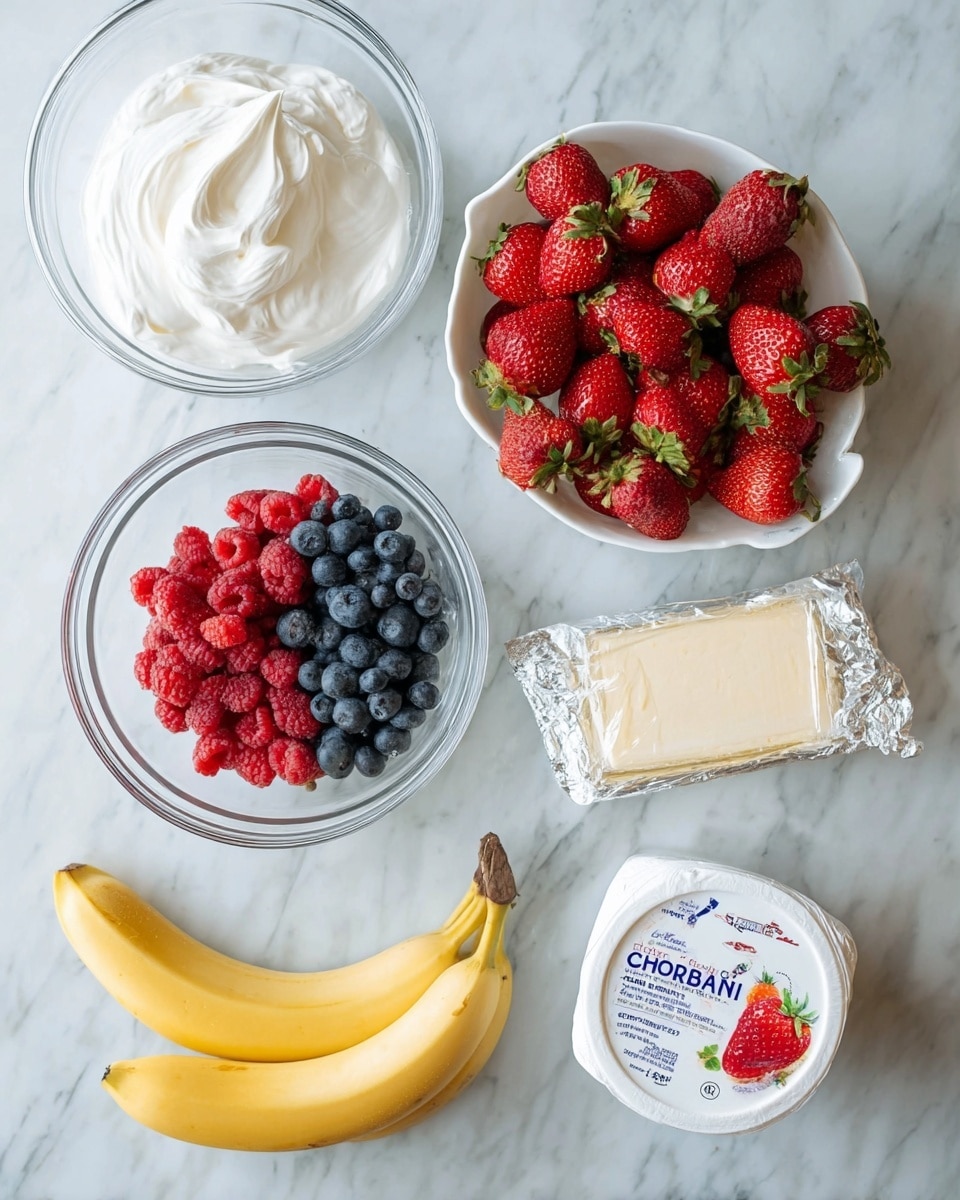 A flat lay on a white marbled surface shows seven items neatly arranged, including two clear glass bowls - one filled with smooth, white whipped cream and the other half filled with small blueberries and bright red raspberries mixed together. Next to those is a white colander bowl full of whole red strawberries with green leaves on top. Below them are a plain yellow ripe banana with small brown spots, a small glass bowl filled with white granulated sugar, a wrapped block of pale yellow cream cheese with measuring guide marks on the silver wrapping, and a white container of Chobani Greek yogurt with strawberry images on the lid. Photo taken with an iphone --ar 4:5 --v 7